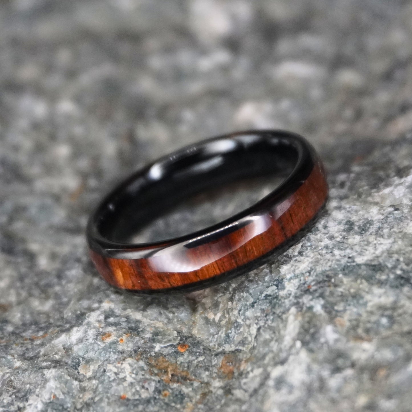 Black comfort fit ring with a wood inlay, 6mm width, by Forge and Lumber. Available in sizes UK K to M.