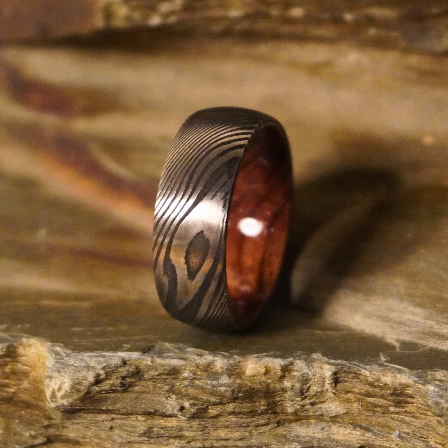Damascus steel commitment ring with a wooden interior by Forge and Lumber, available in sizes UK M, N, O.