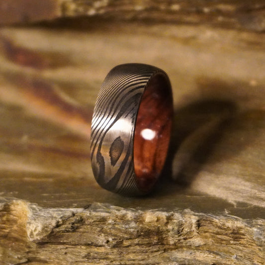 Damascus steel commitment ring with a wooden interior by Forge and Lumber, available in sizes UK M, N, O.