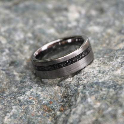 Durable 8mm cosmic ring with engravable black inlay by Forge and Lumber, displayed on textured stone surface.
