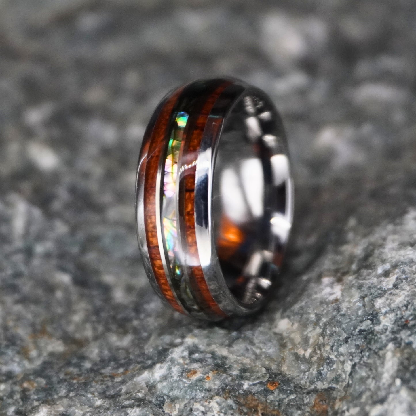 Black and abalone inlay 8mm wedding band by Forge and Lumber, featuring wood accents and polished finish.