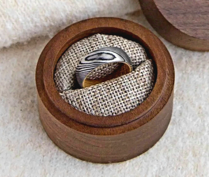 Damascus steel 8mm wedding band in a wooden display box by Forge and Lumber.