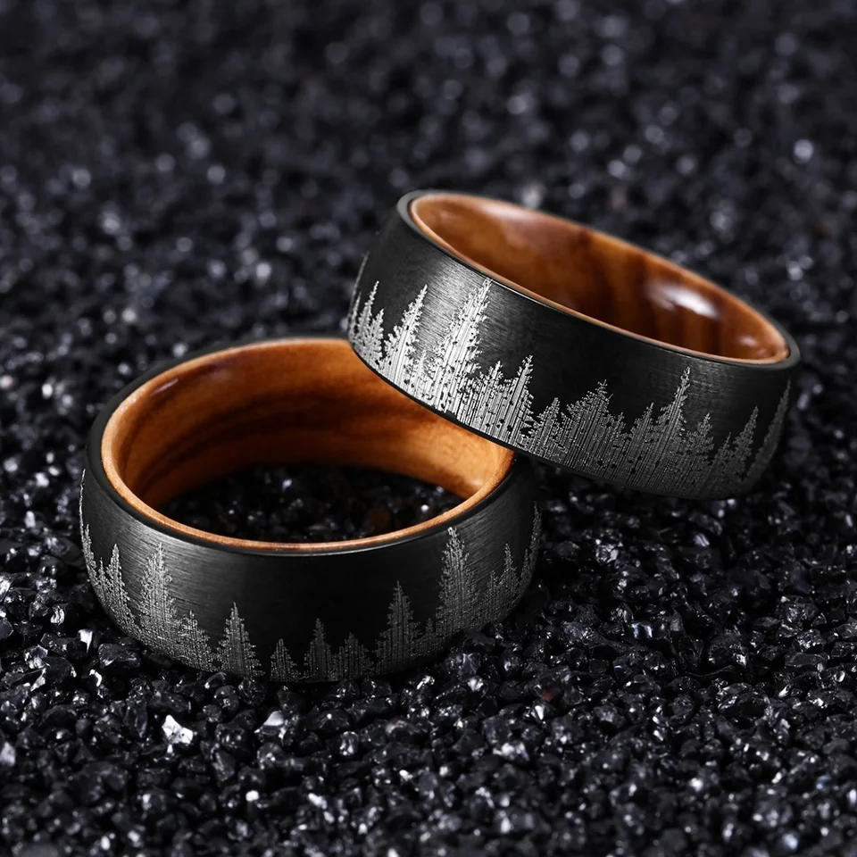 Black durable ring with engraved forest design and wooden interior by Forge and Lumber.