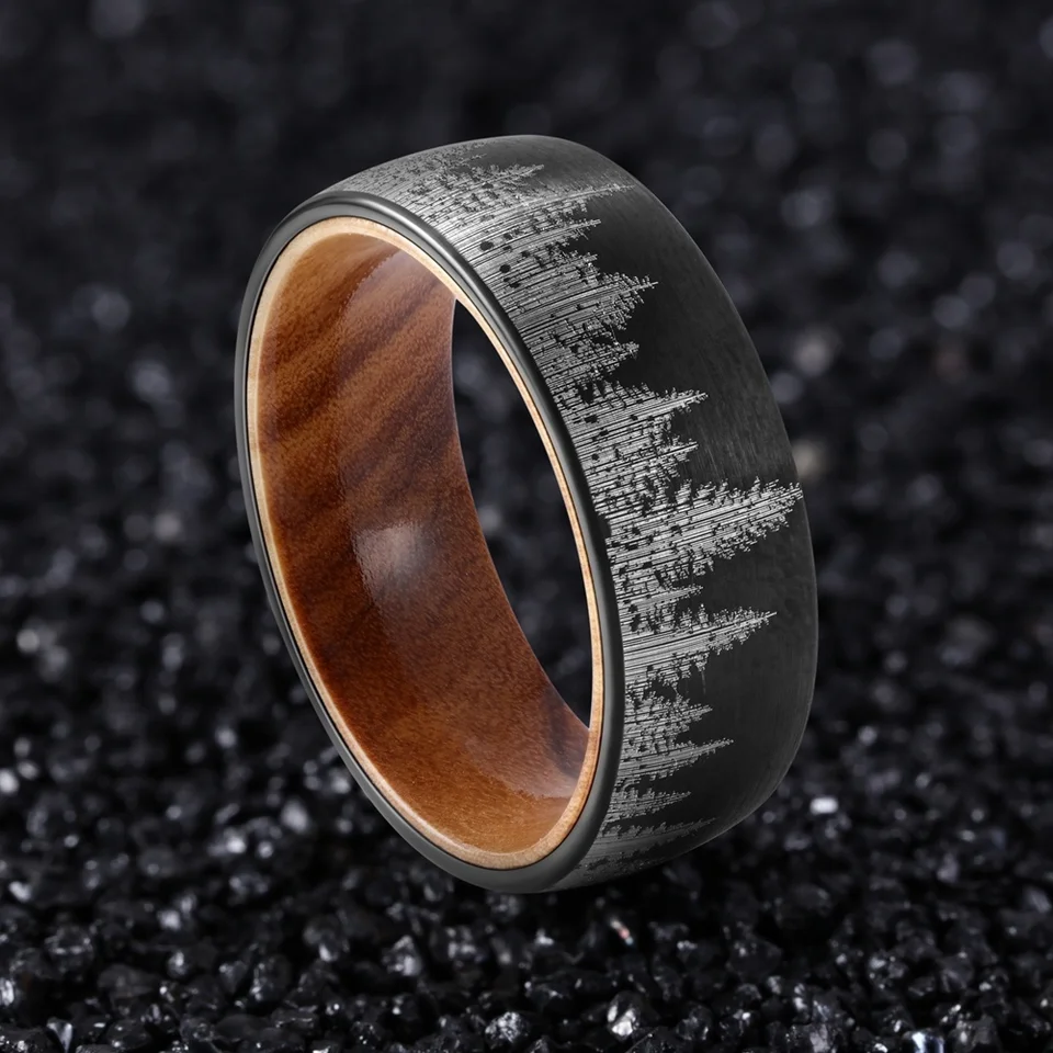 Black durable ring with engraved mountain design and wooden interior by Forge and Lumber.