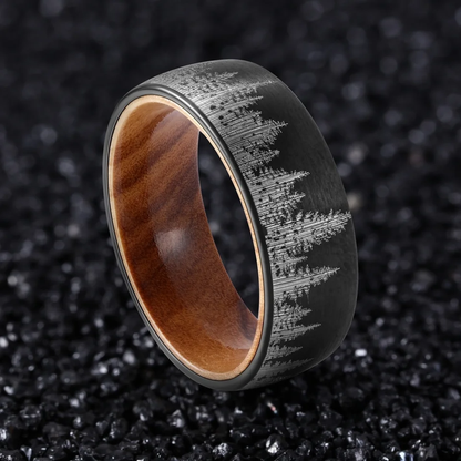 Black durable ring with engraved mountain design and wooden interior by Forge and Lumber.