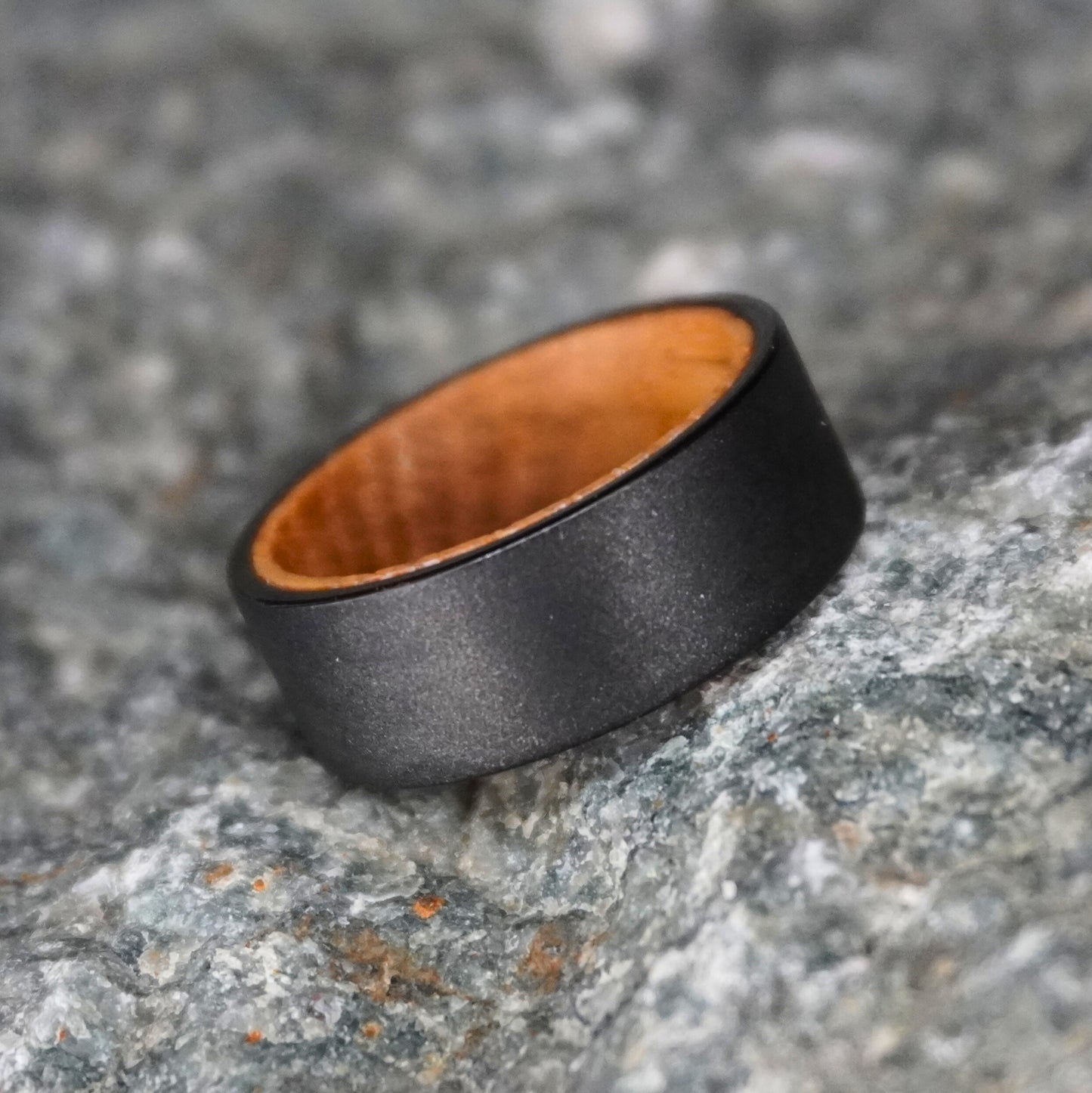 Black artisan ring made from barrel wood by Forge and Lumber, featuring a smooth matte finish.