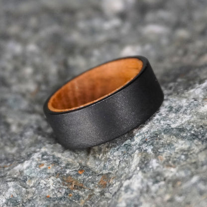 Black artisan ring made from barrel wood by Forge and Lumber, featuring a smooth matte finish.