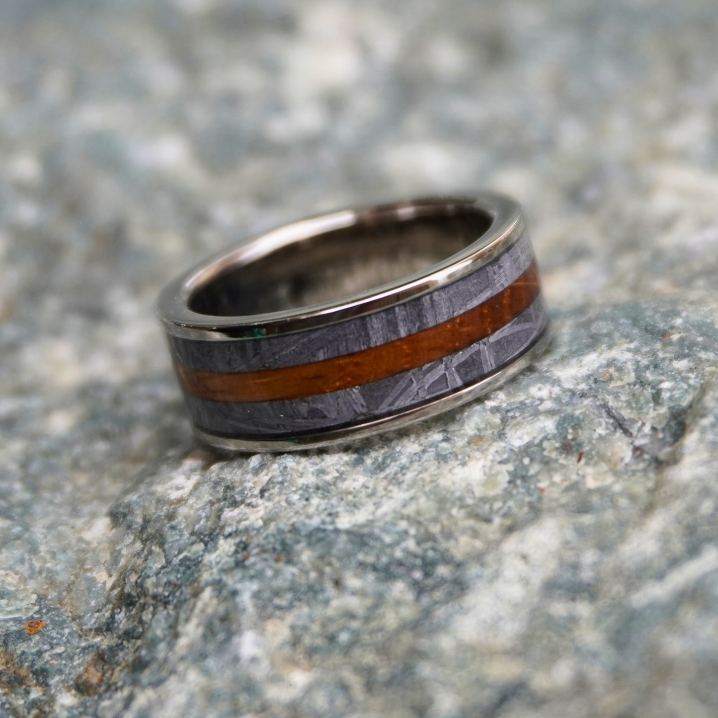 Artisan 8mm ring made from barrel wood with gray and orange stripes by Forge and Lumber.