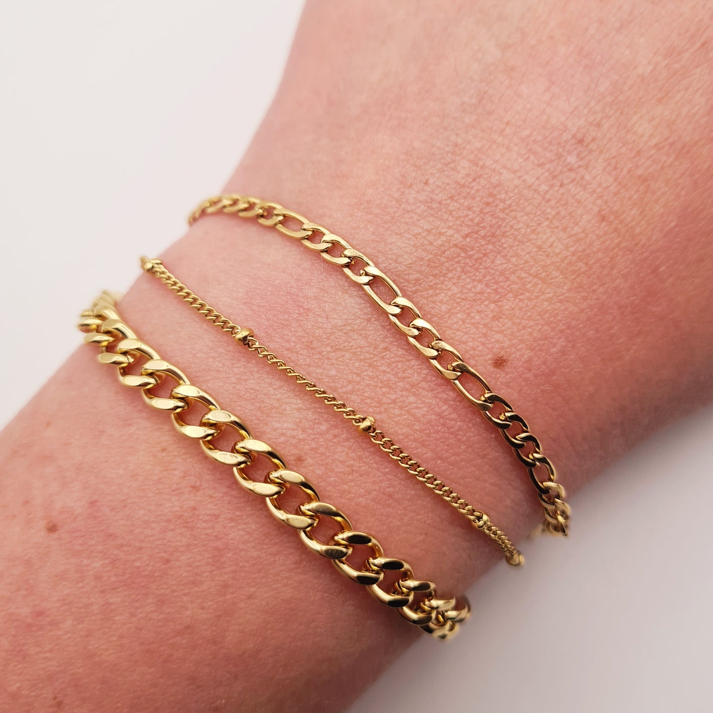 Chunky gold bracelet, 18K plated, adjustable, waterproof, tarnish-free, worn on wrist.