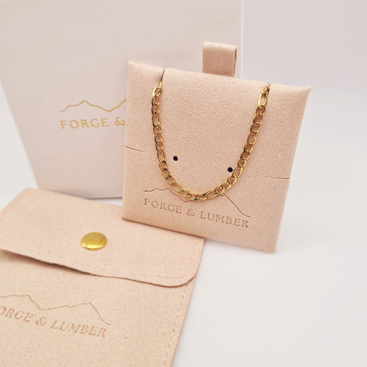 18K gold plated chain bracelet from Forge and Lumber, waterproof and tarnish-free, displayed in a soft pouch.