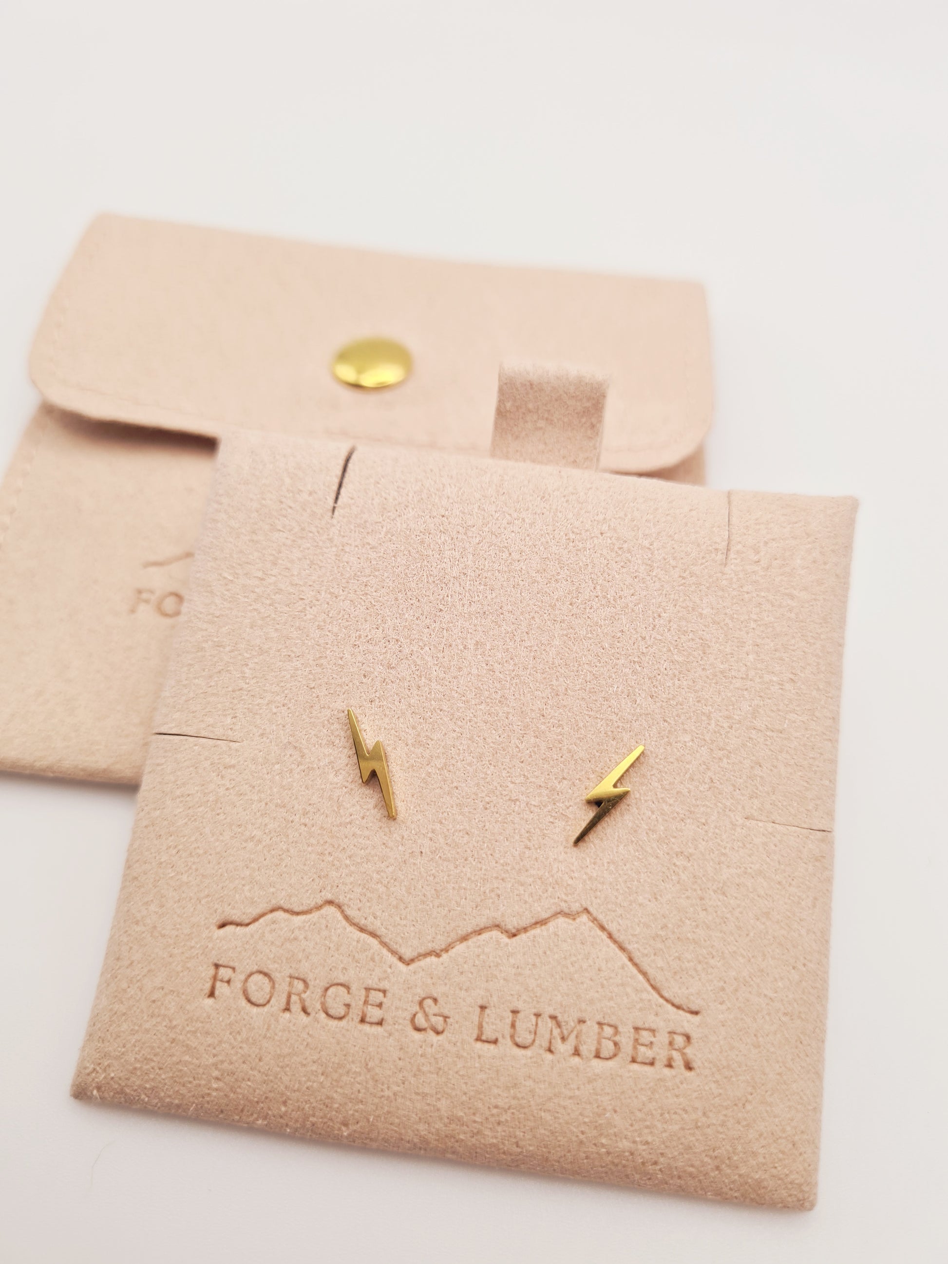 18K gold plated lightning bolt stud earrings by Forge and Lumber, geometric design in stainless steel.