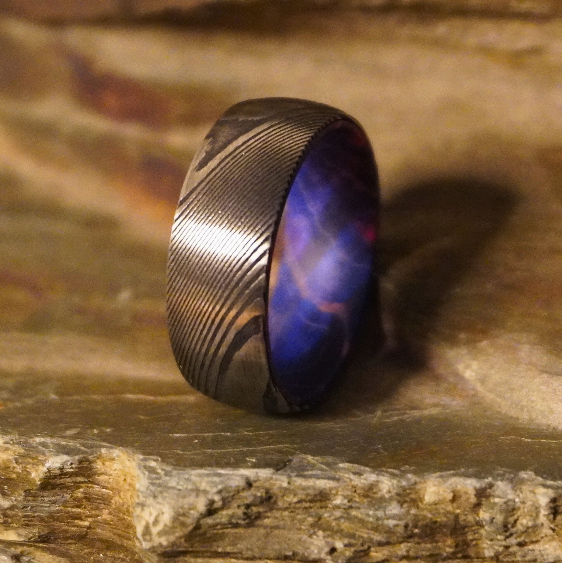 Damascus steel ring with artisan design, featuring a unique pattern, from Forge and Lumber, available in various sizes.