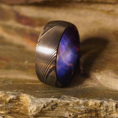 Damascus steel ring with artisan design, featuring a unique pattern, from Forge and Lumber, available in various sizes.