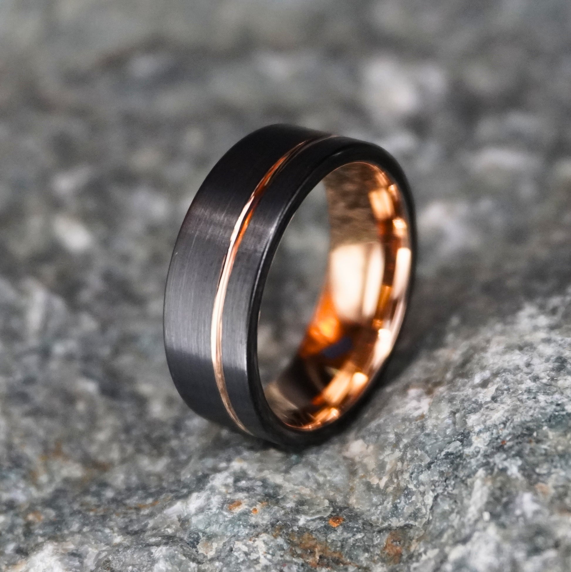 Black and rose gold 8mm wedding band from Forge and Lumber, featuring a brushed finish and blacksmith-inspired design.