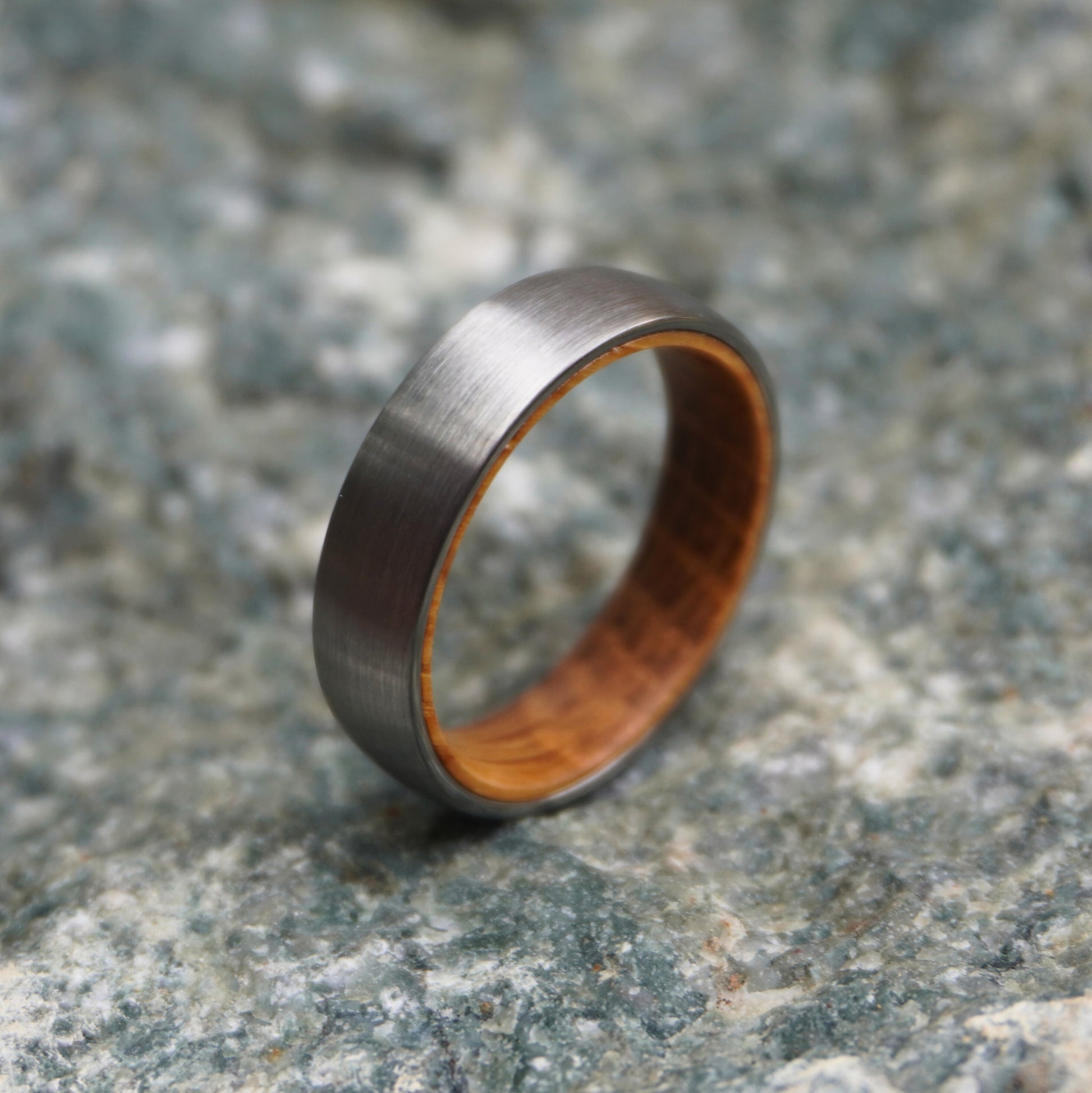 Black band ring with a brushed finish and wooden interior by Forge and Lumber. Available in sizes UK K to M.