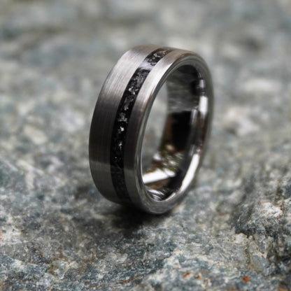 Durable 8mm cosmic ring with engravable black inlay by Forge and Lumber, shown on textured stone background.