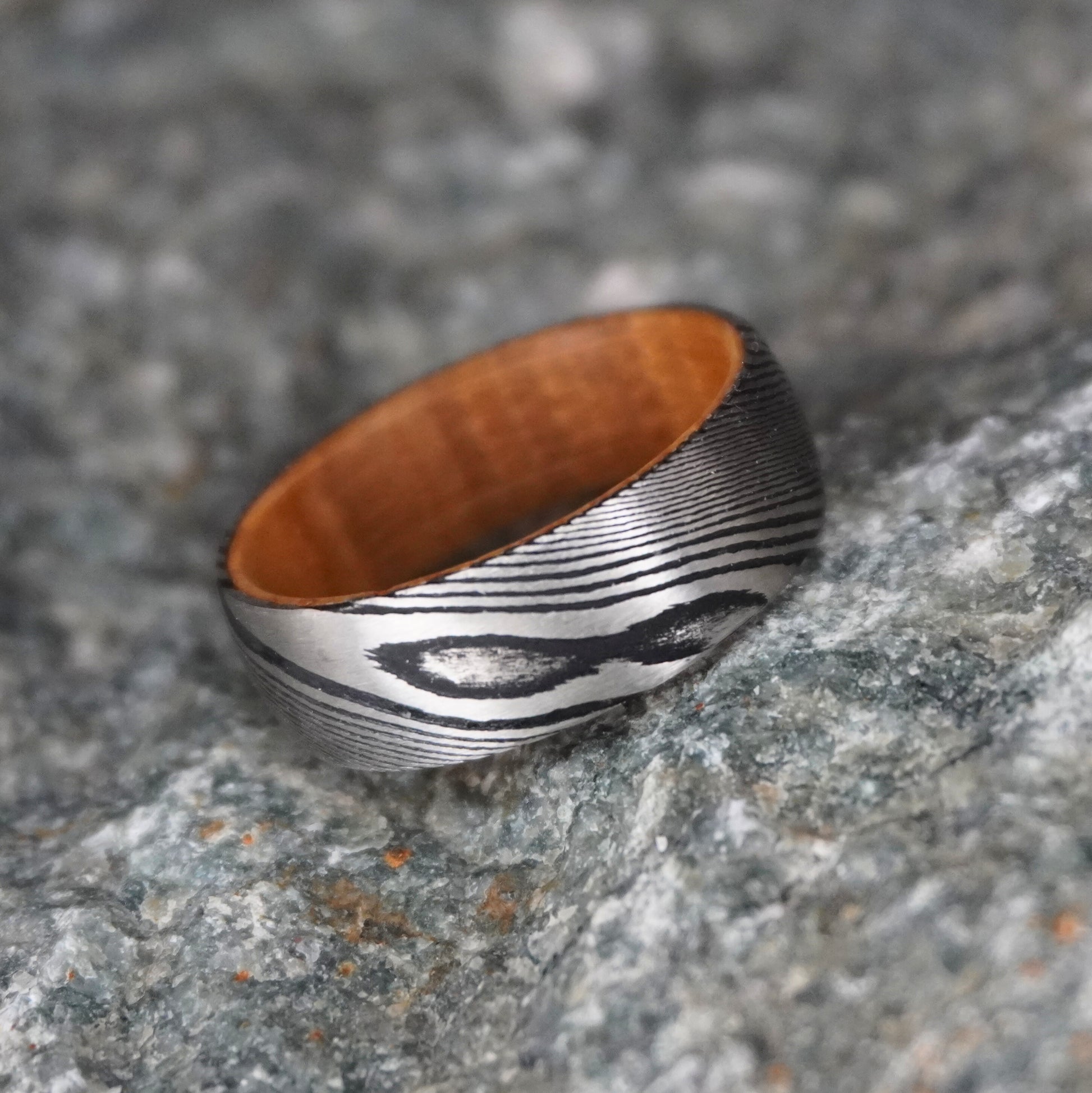 Damascus steel wedding band with wooden interior, 8mm width, by Forge and Lumber. Available in sizes UK M, N, O.