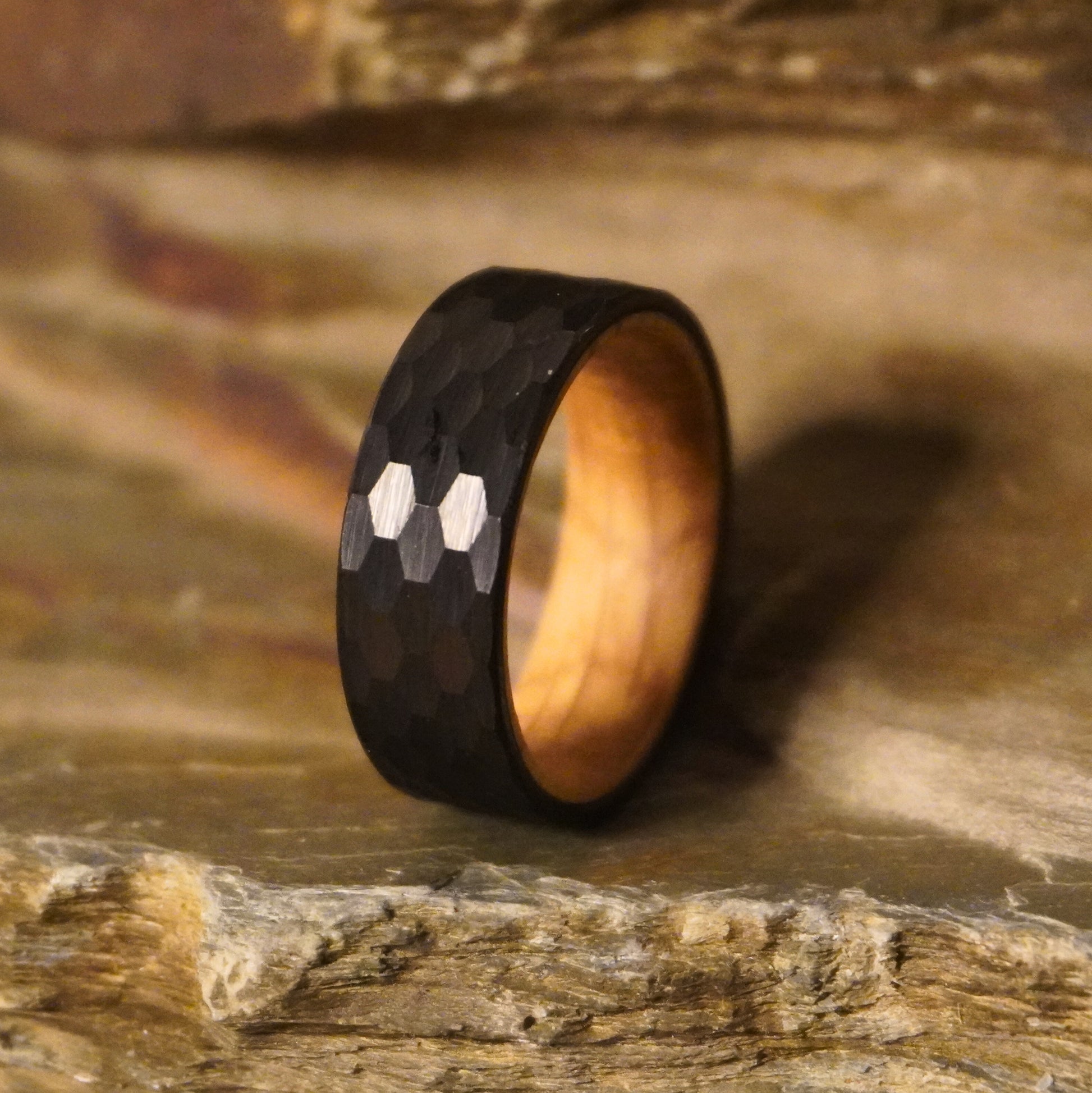 Black 8mm flat ring with hexagonal pattern and wooden interior by Forge and Lumber.