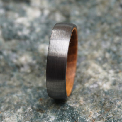 Black 6mm band ring with a brushed finish and wooden interior by Forge and Lumber.