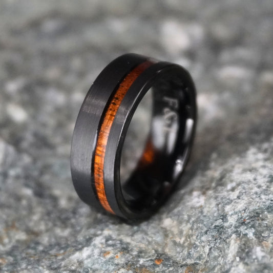 Black brushed finish 8mm ring with a wood inlay by Forge and Lumber, available in sizes UK M to O.
