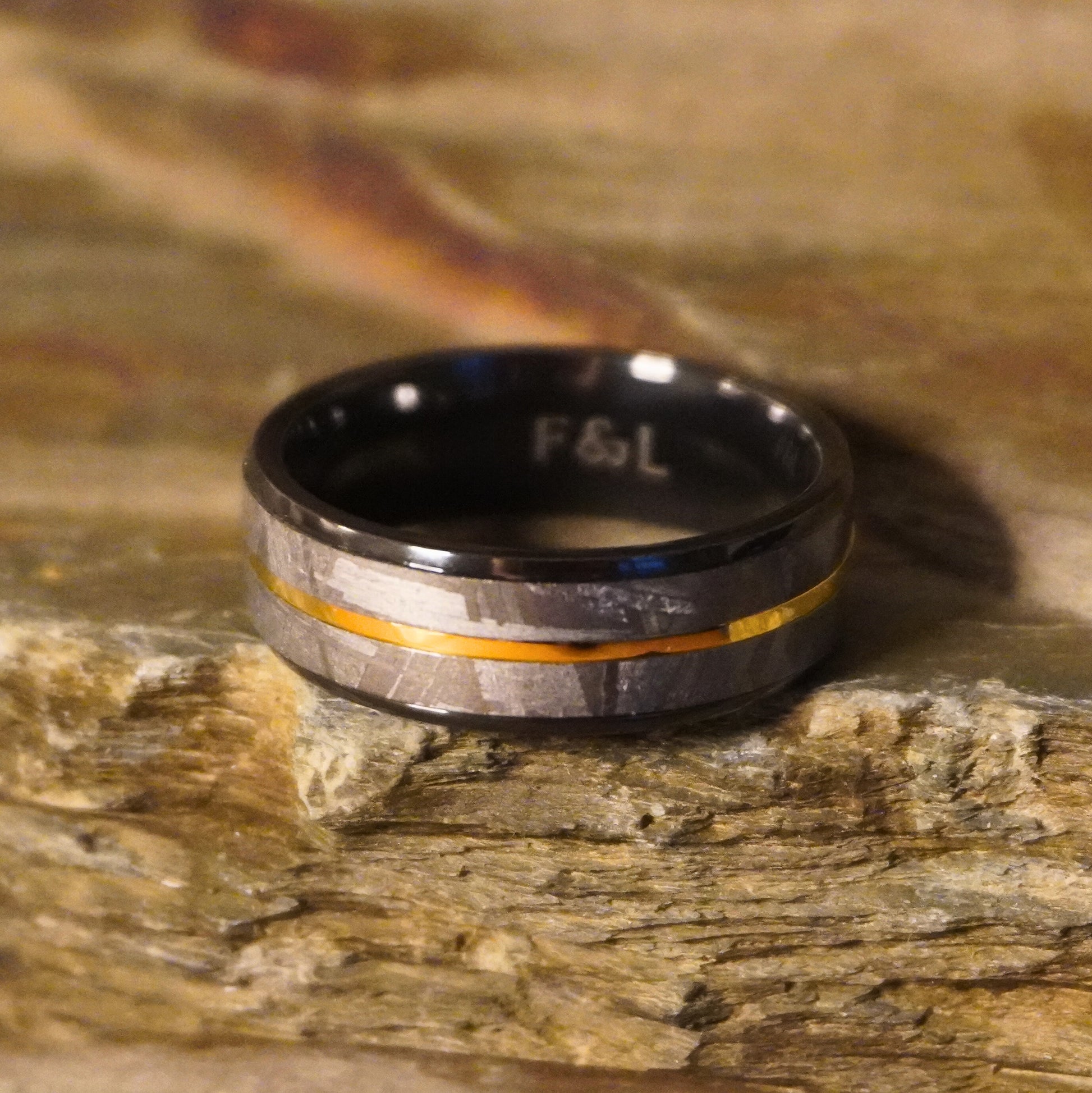 Black Zirconium wedding ring with a gold inlay by Forge and Lumber, featuring a sleek, modern design.