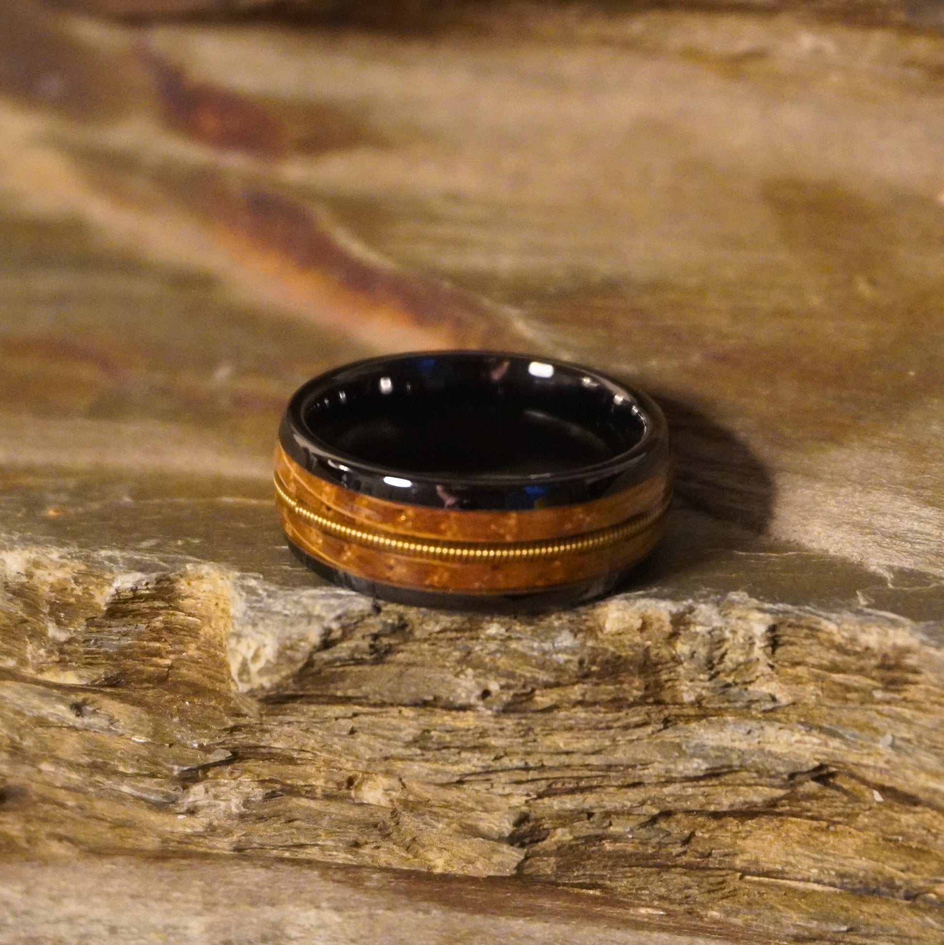 Black ceramic ring with a wood inlay, featuring a textured design, by Forge and Lumber. Size UK M / US 6.