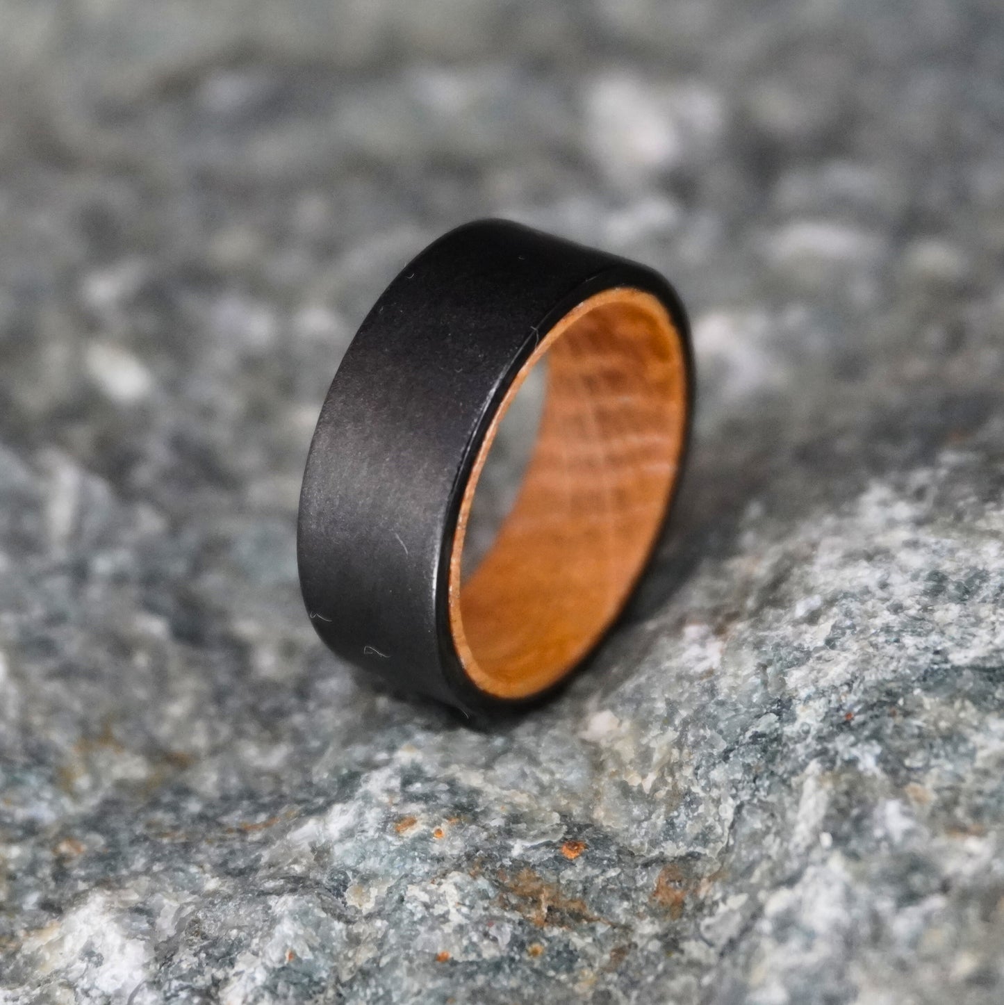 Black artisan ring made from barrel wood by Forge and Lumber, featuring an 8mm width.