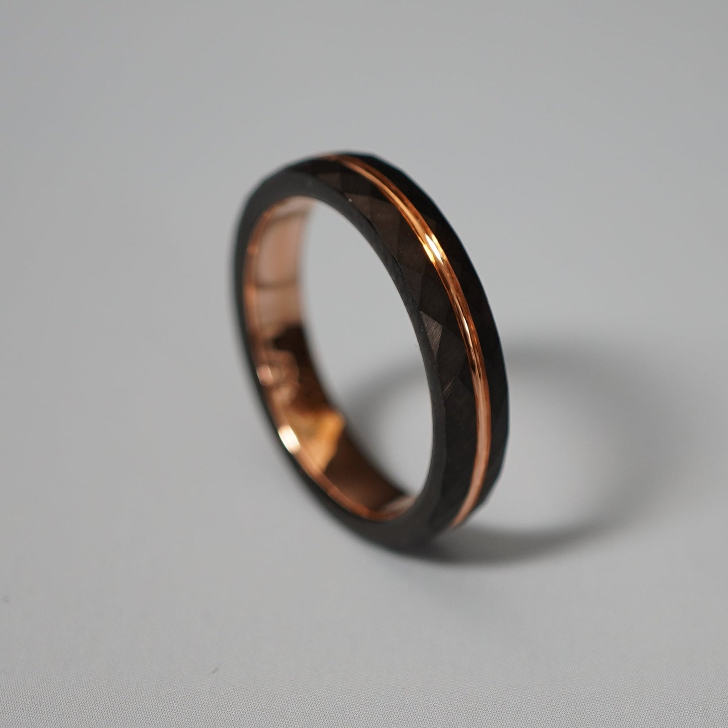 Black and rose gold engraved wedding band by Forge and Lumber, 4mm delicate design, available in multiple sizes.