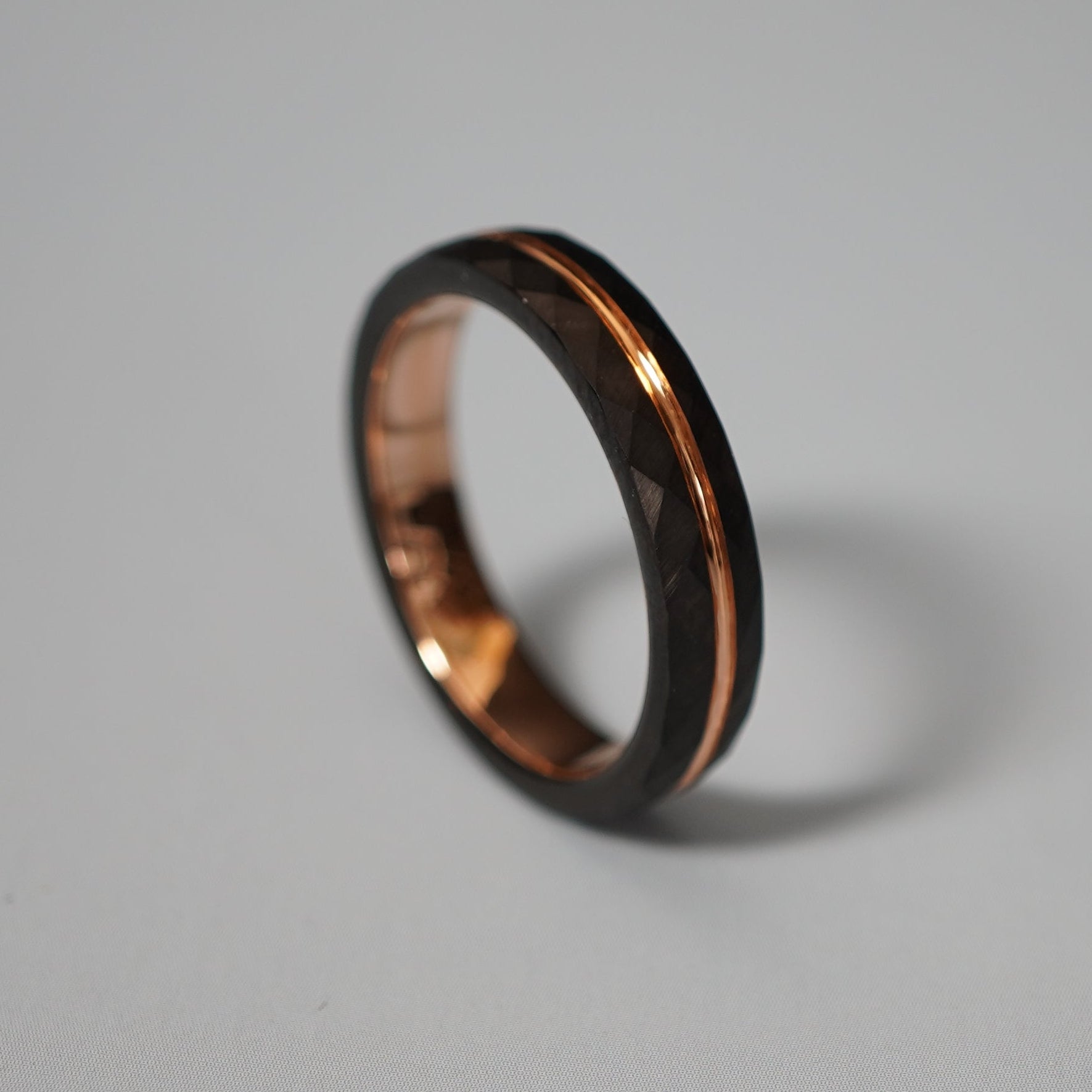 Black and rose gold engraved wedding band by Forge and Lumber, 4mm delicate design, available in multiple sizes.