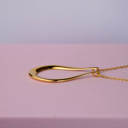 The Abalone ring holder necklace in gold, teardrop pendant on a fine chain