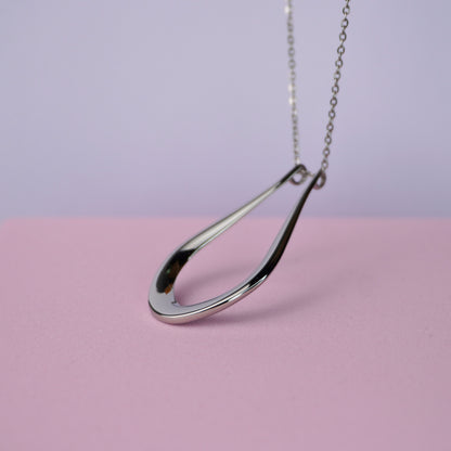 The Abalone silver teardrop ring holder pendant, shown close up