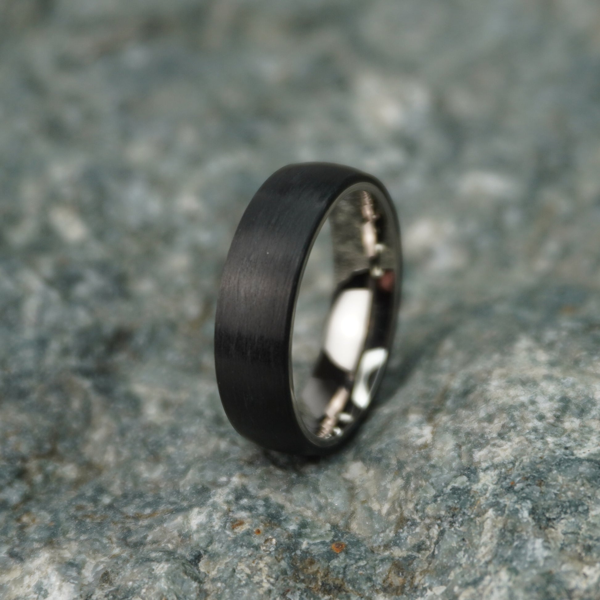 Black 6mm carbon fiber ring by Forge and Lumber, featuring a sleek, brushed finish.