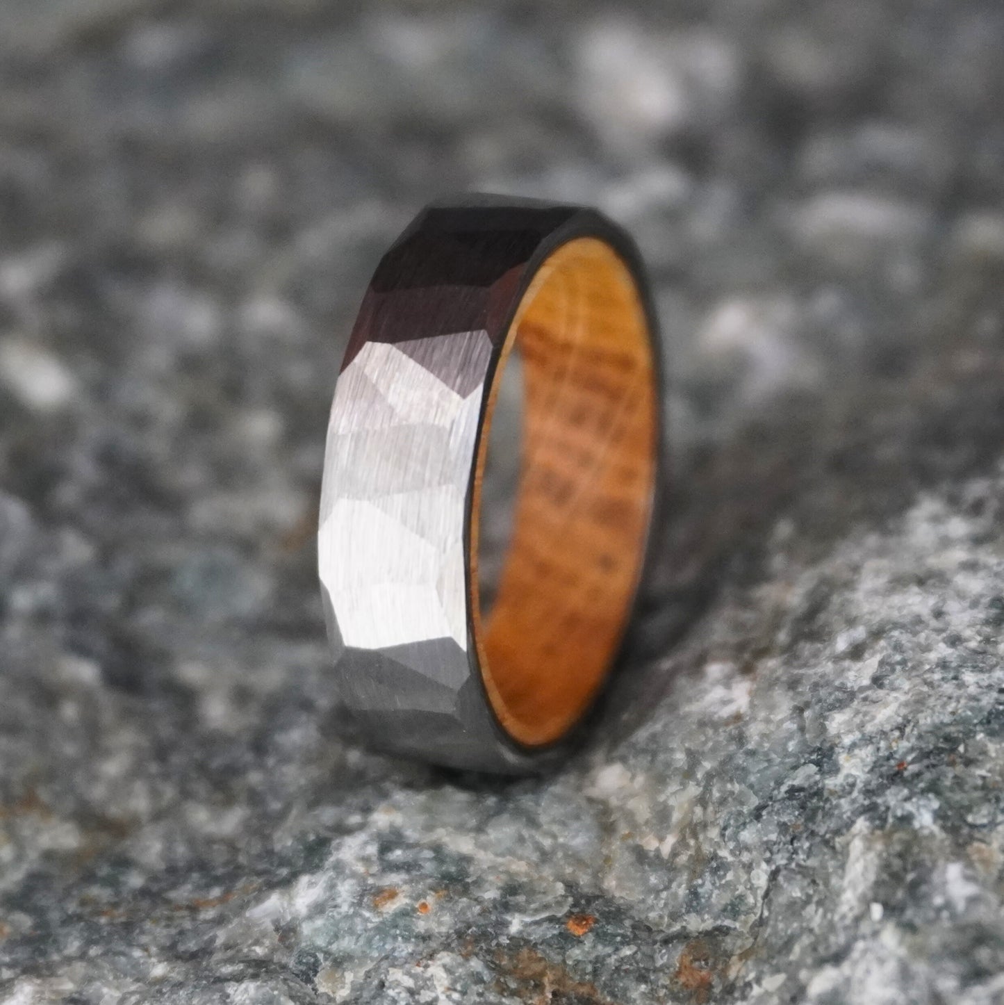 Durable barrel-inspired ring with a faceted metal exterior and wooden interior by Forge and Lumber.