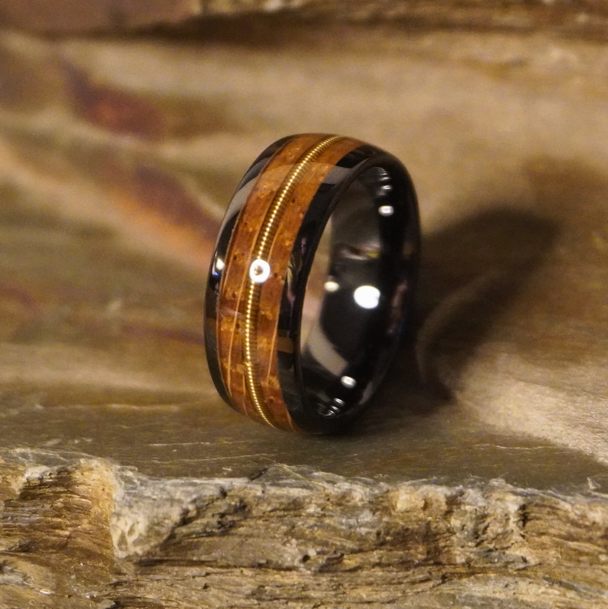 Black ceramic wedding band with wood inlay and silver accent, by Forge and Lumber. Size UK M / US 6.