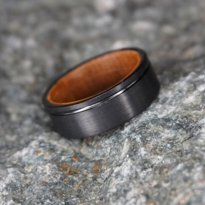 Black brushed 8mm barrel ring with wooden interior by Forge and Lumber. Available in UK sizes M, N, O.