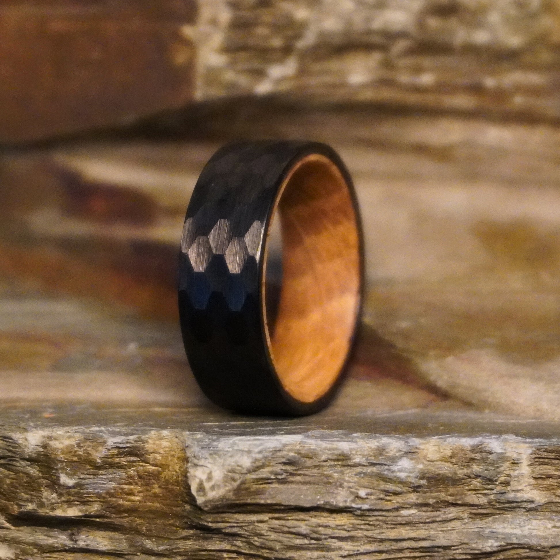 Black 8mm flat ring with a durable design and wooden interior by Forge and Lumber.