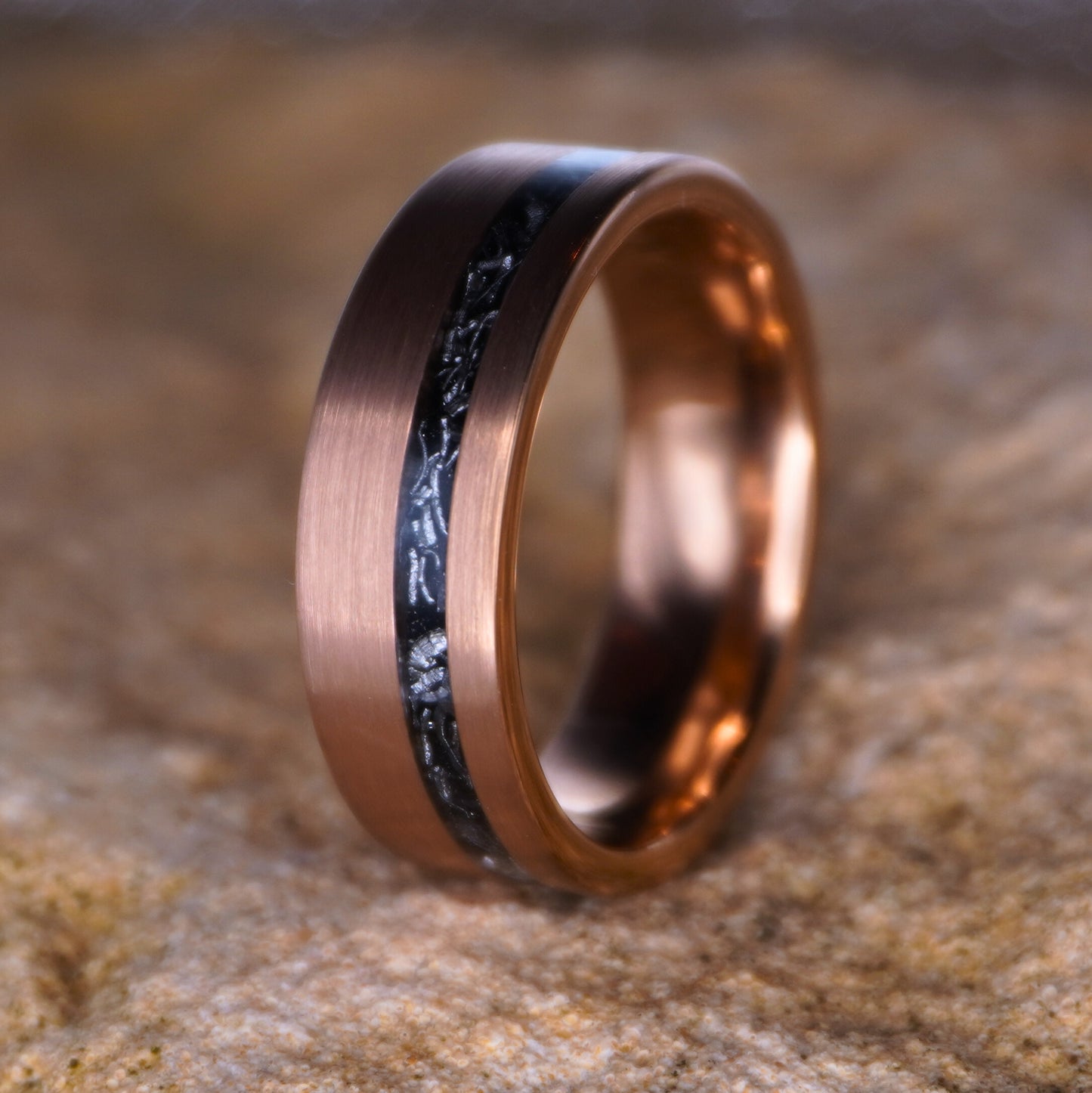Rose gold 8mm wedding band with black inlay, featuring a brushed finish by Forge and Lumber.