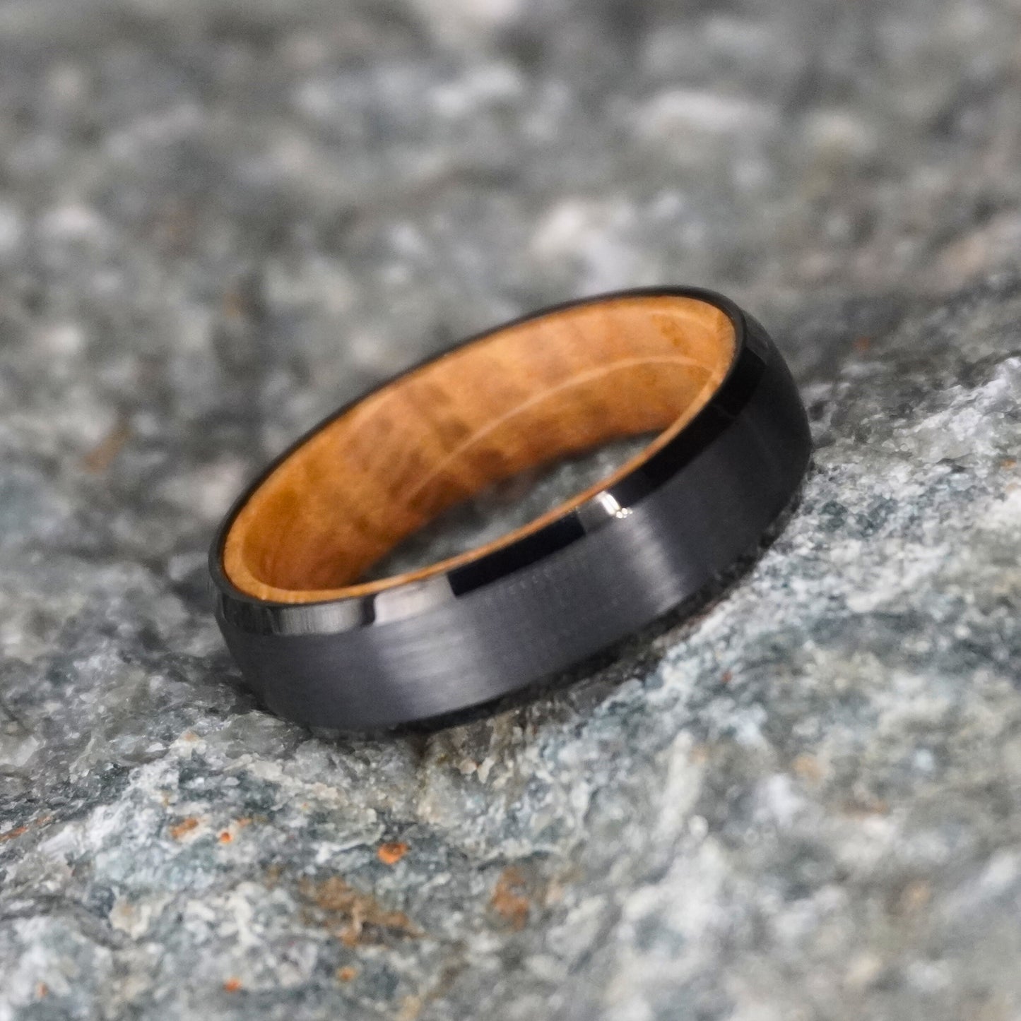 Black beveled ring with 6mm width and barrel wood interior by Forge and Lumber.