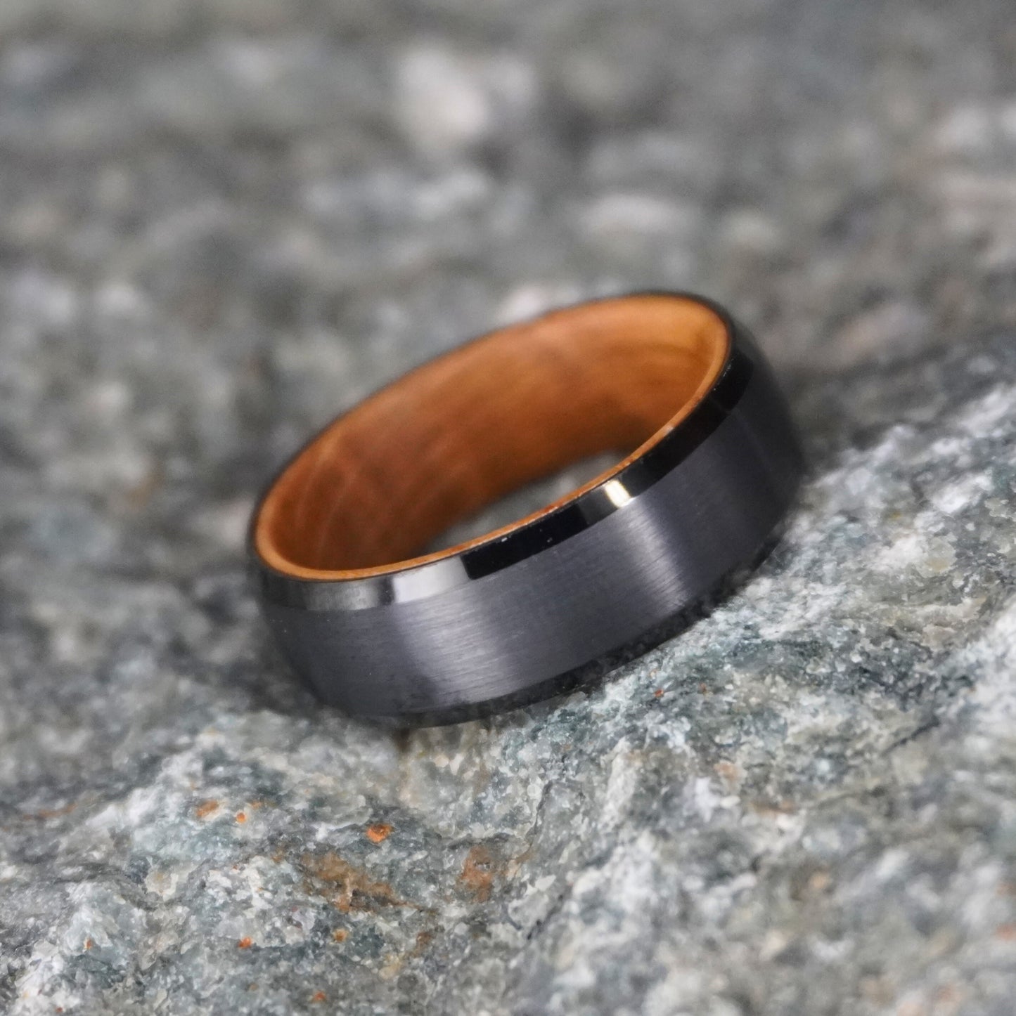 Beveled-edge black ring with barrel-wood interior, 8mm width, by Forge and Lumber.