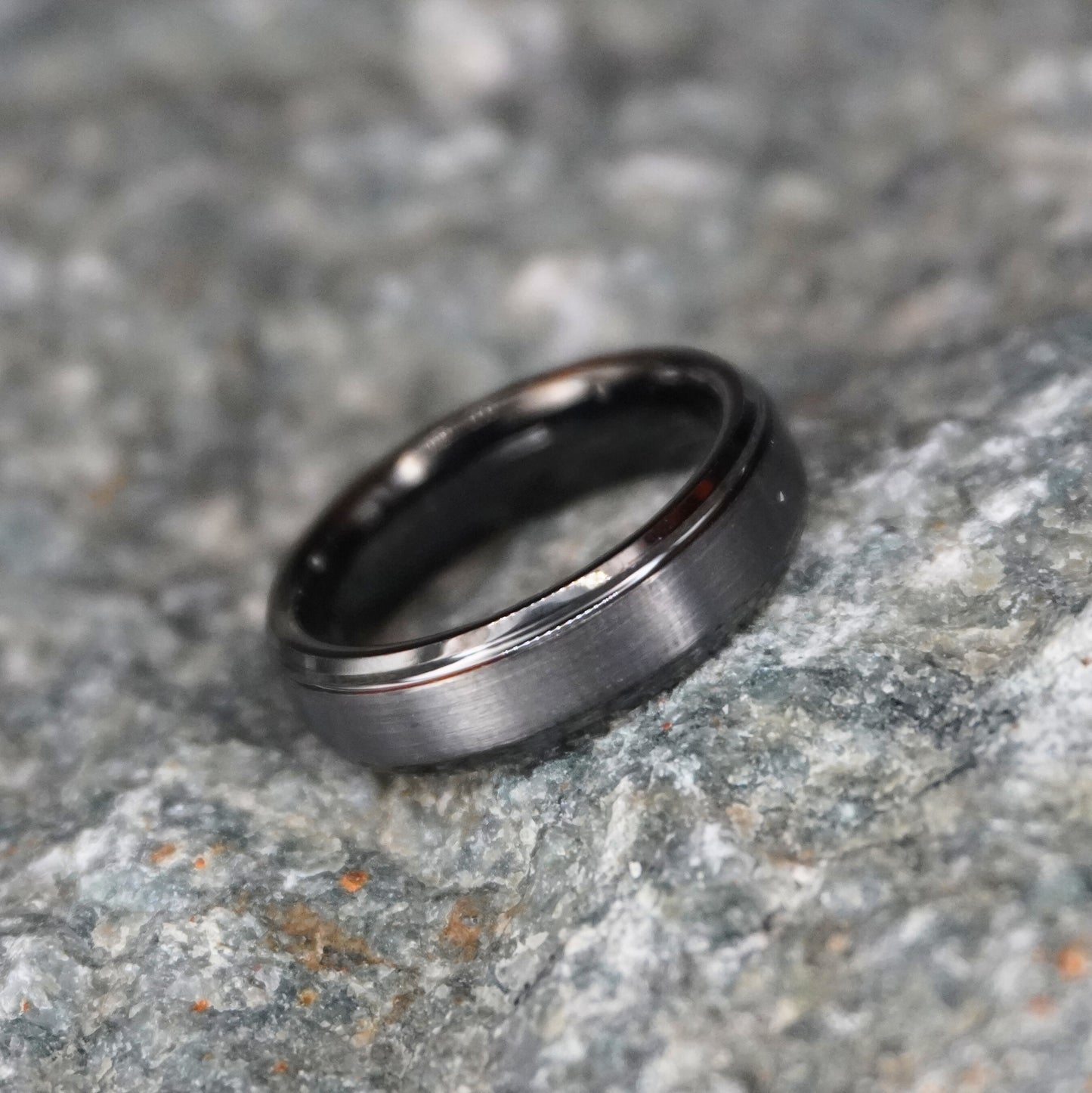 Beveled tungsten wedding band in black, featuring a sleek design by Forge and Lumber.