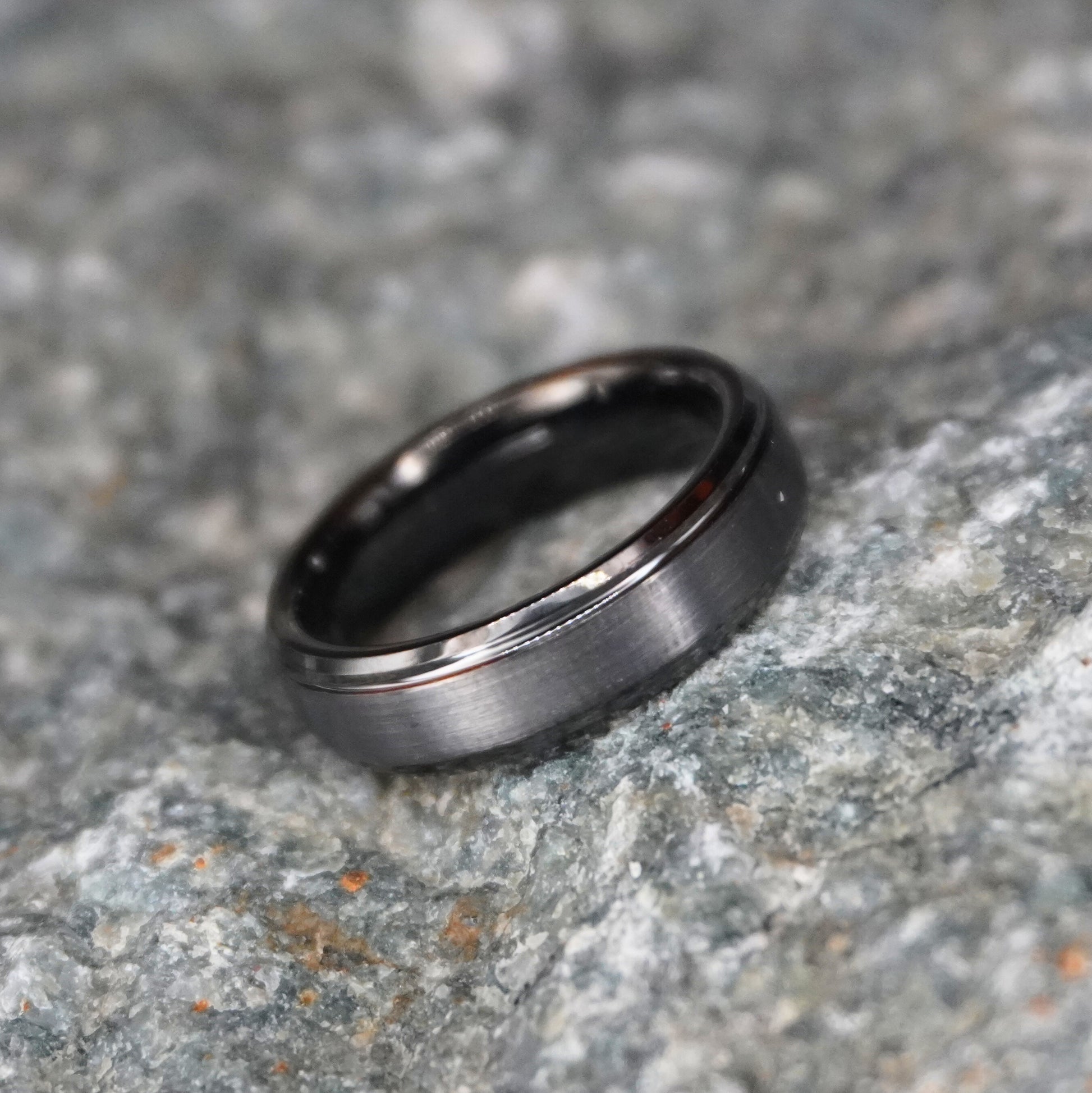 Beveled tungsten wedding band in black, featuring a sleek design by Forge and Lumber.