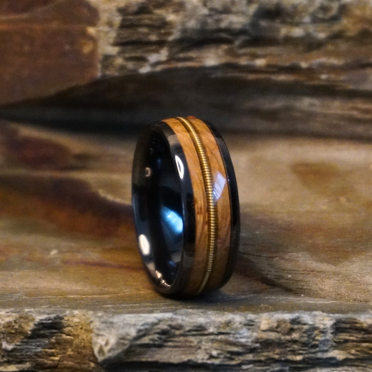 Black ceramic wedding band with wood inlay, 8mm width, by Forge and Lumber, available in sizes UK M, N, O.