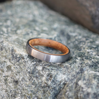 Brushed stainless steel 4mm wedding band with a wooden inner lining by Forge and Lumber.