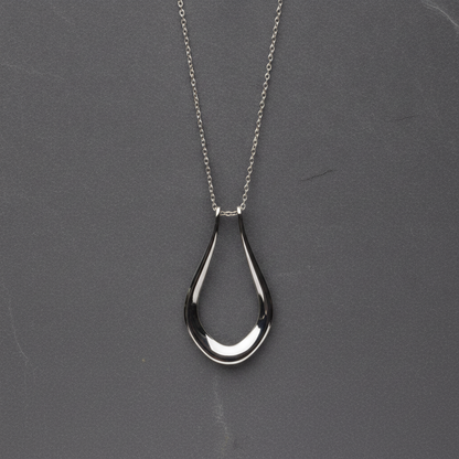 The Abalone necklace worn with a ring on the chain