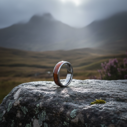 Acacia wood wedding ring by Forge and Lumber, 6mm comfort band, size UK K / US 5, displayed on a stone background.