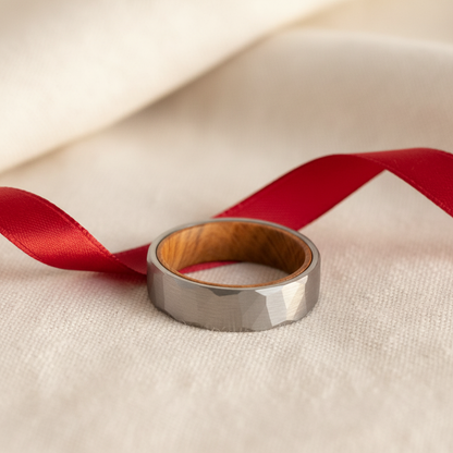 Barrel-inspired comfort-fit ring by Forge and Lumber, 6mm wide with a gray exterior and wooden interior.
