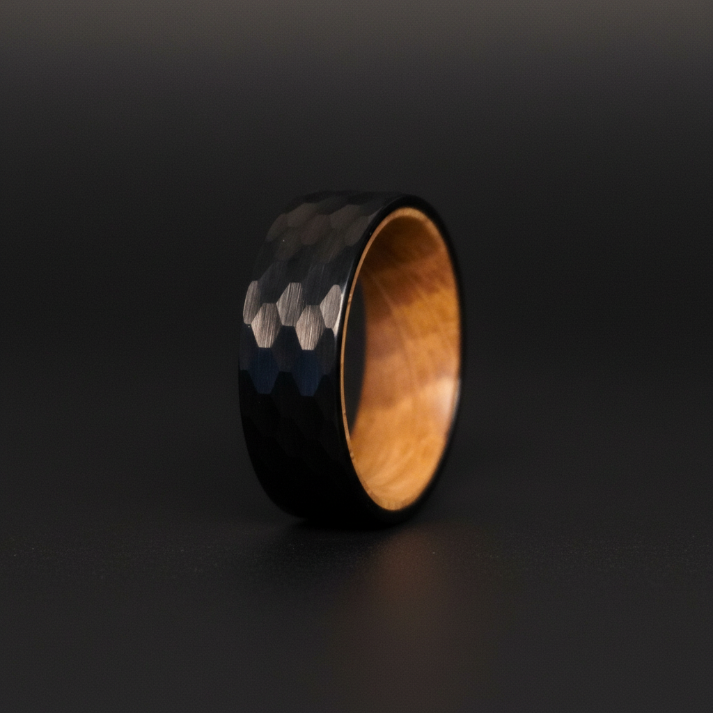 Sleek black hexagonal-patterned ring with a wooden interior, titled "The Iona." Perfect for modern jewelry enthusiasts.