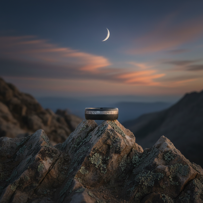 Black Zirconium wedding band from Forge and Lumber, 8mm, set against a mountain sunset backdrop.