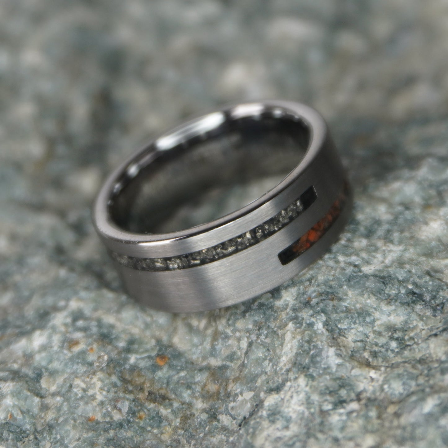 Forge and Lumber The Impact ring with 8mm cosmic Dinosaur Bone inlay and engravable black titanium band.
