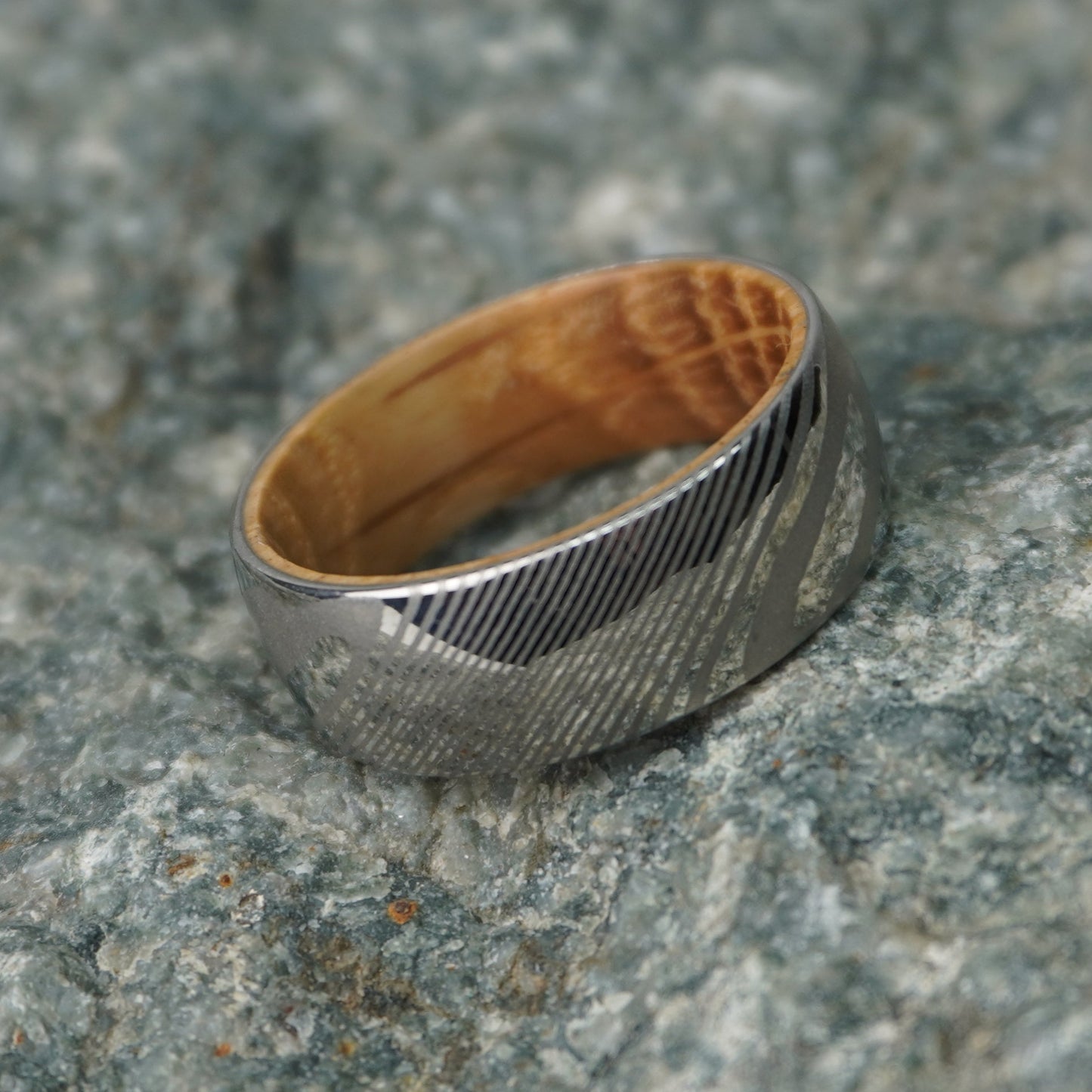 Artisan Damascus ring with a wood interior, by Forge and Lumber, available in sizes UK M, N, O.